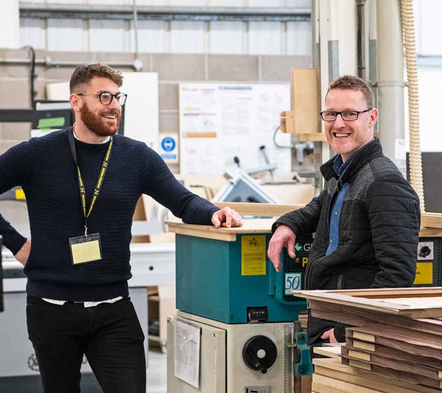 Members of Axminster Tools Executive Team smiling in the factory 