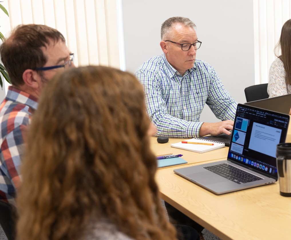 website design agency Devon People at a desk in front of laptops having training