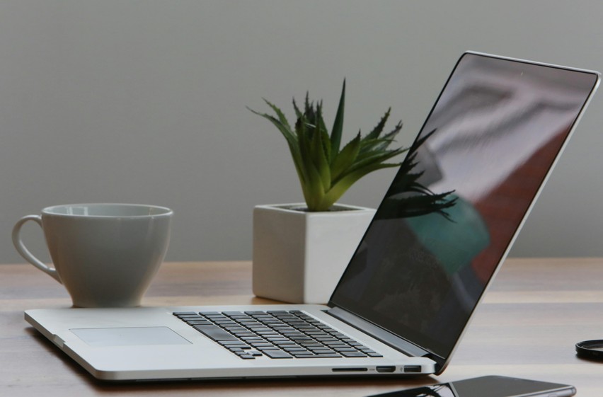 Laptop on desk with coffee