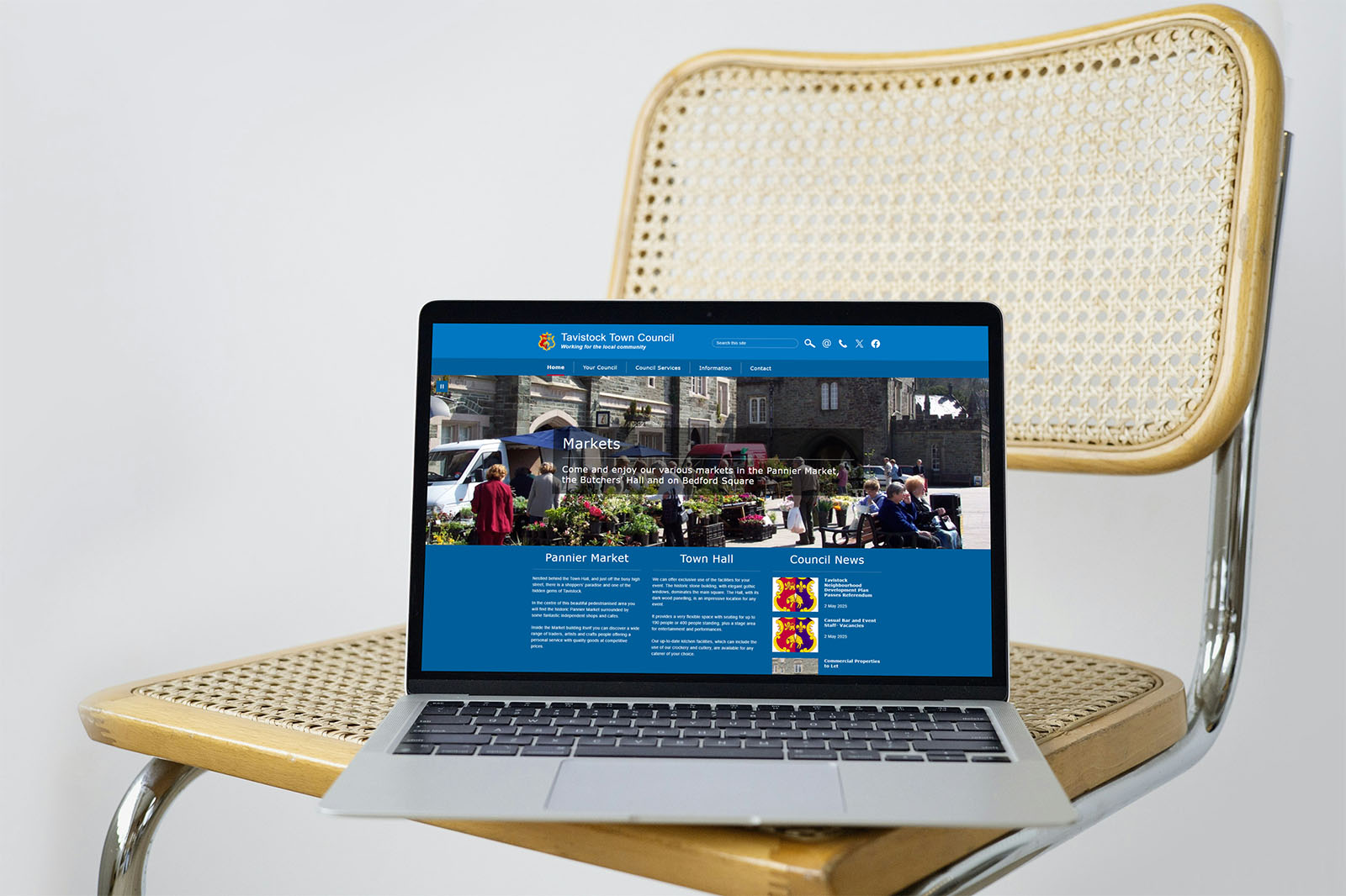 Tavistock Town Council website on a laptop resting on a chair.