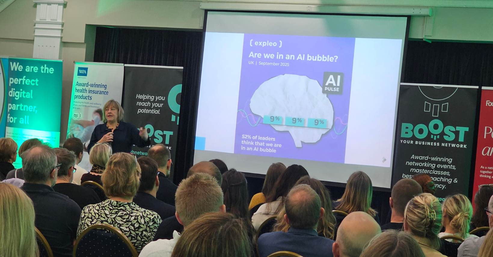 Julie Hawker delivering a keynote speech at the Boost Your Business networking event, addressing AI and digital skills.