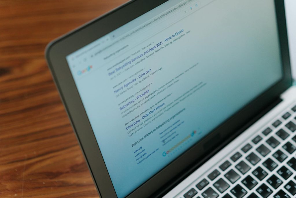 A laptop with a series of Google search results
