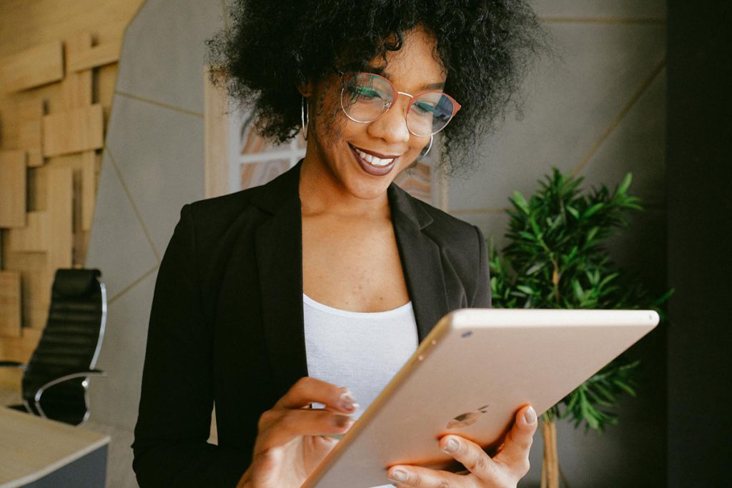 A woman looking at and using an iPad